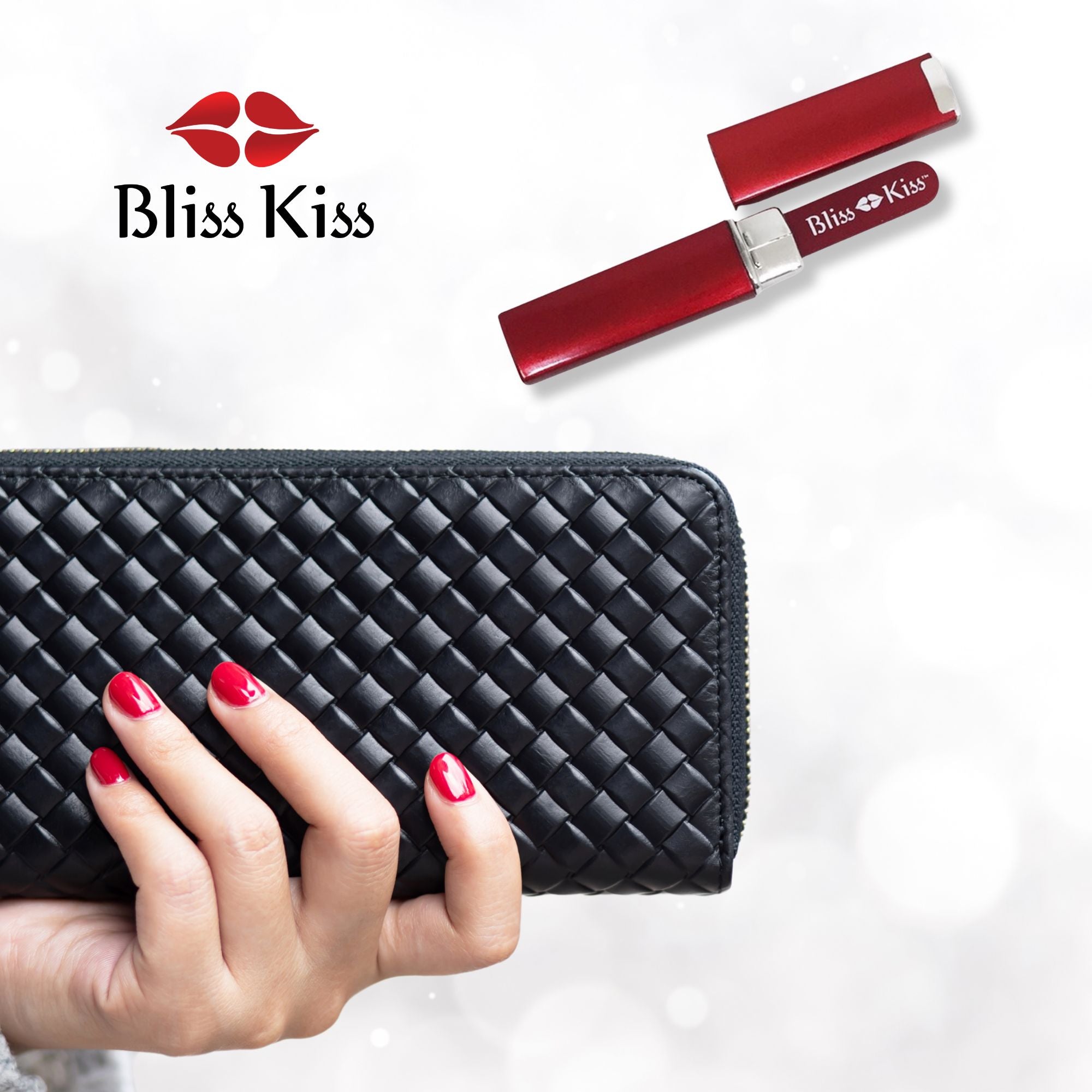 Bliss Kiss. Image shows a well manicured hand with red nails holding a classy black handbag. beside it is a red Bliss Kiss nano nail file